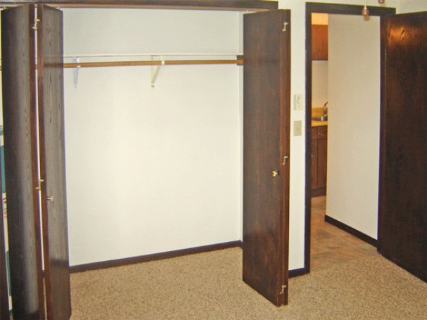 Bedroom with Open Closet Doors